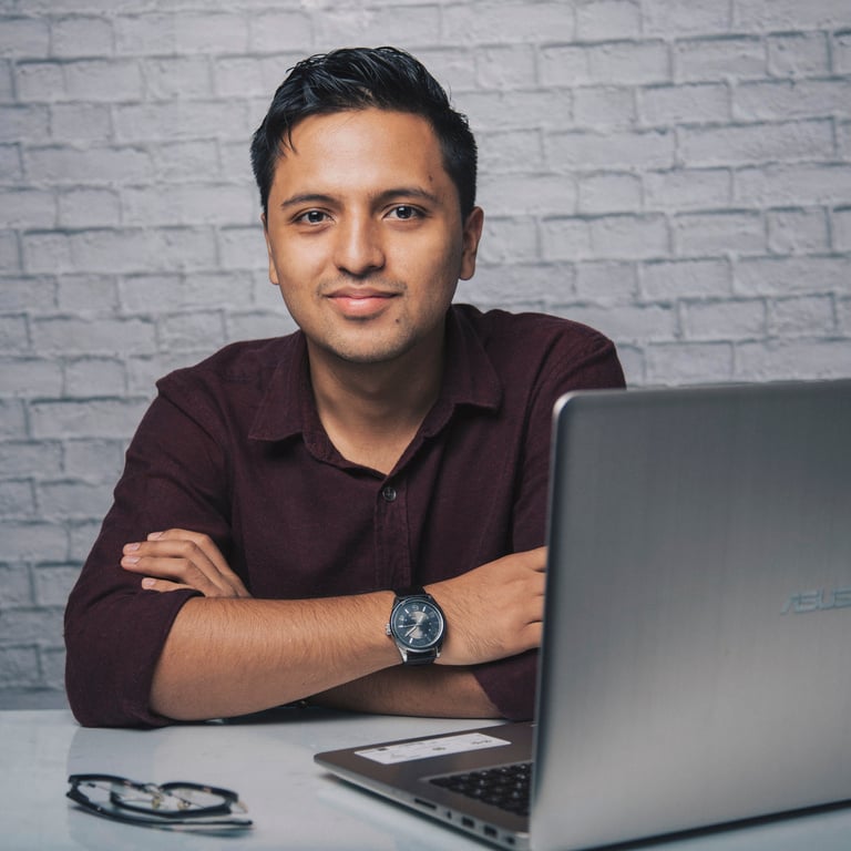 Smiling man with laptop and eyeglasses